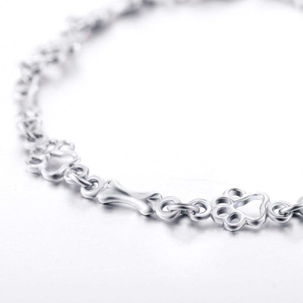 Armband mit hängenden Hundepfoten und Knochen aus Weissgold, Limitierte Auflage