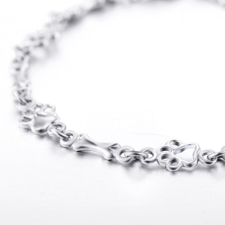 Armband mit hängenden Hundepfoten und Knochen aus Weissgold, Limitierte Auflage