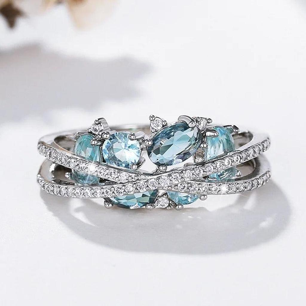 Ring mit Kreuz aus Weissgold und blauem Edelstein
